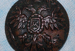 Knoflík, odznak a talisman